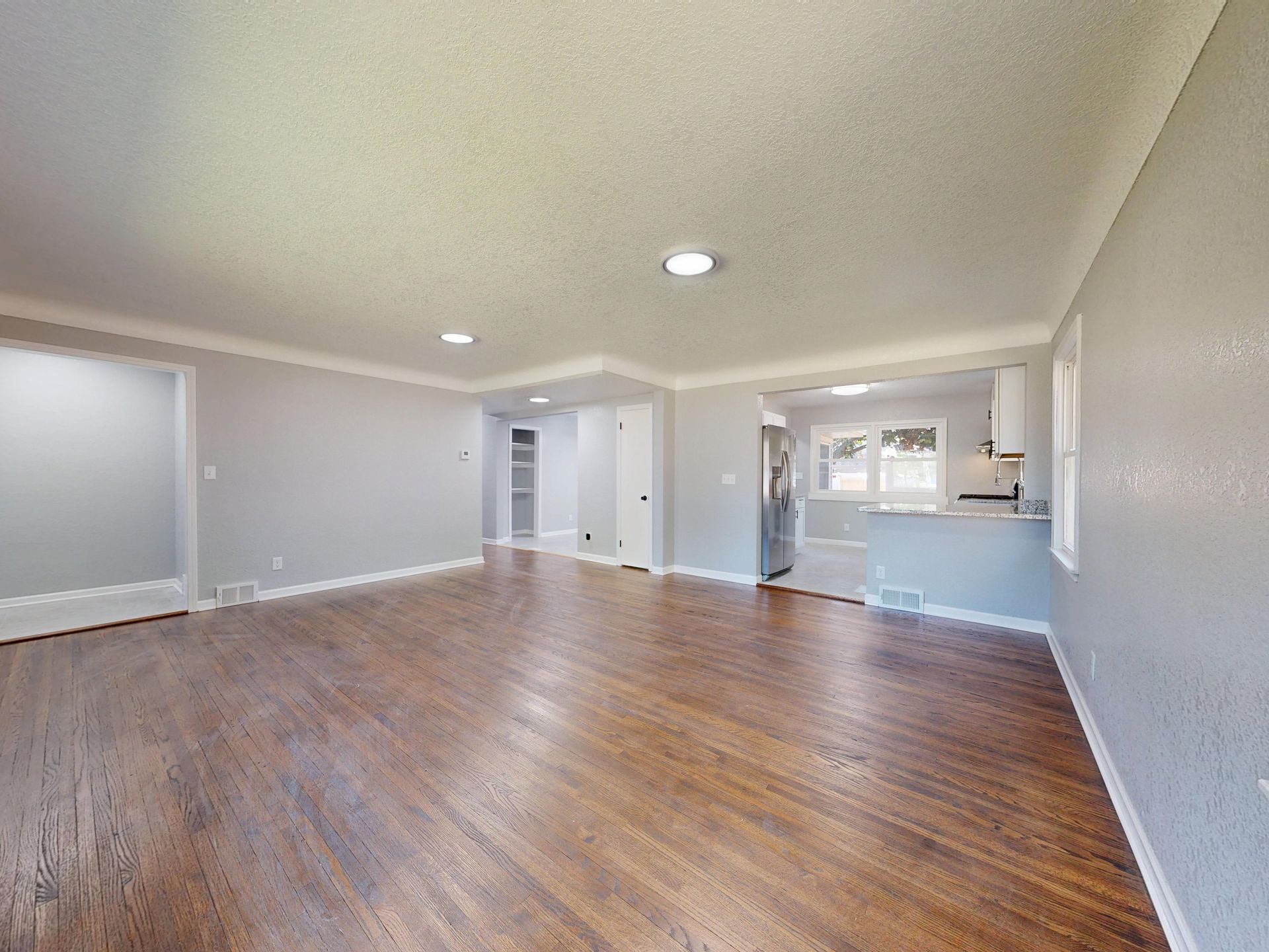 Open and bright living room with hardwood floors and natural light.
